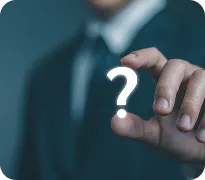 Businessperson in suit pointing at floating illuminated question mark symbol.